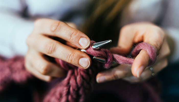 Person learning to knit