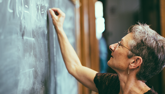 Woman writing list on chalkboard