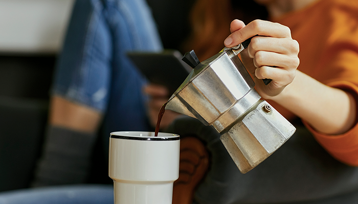 Woman pouring coffee in mug